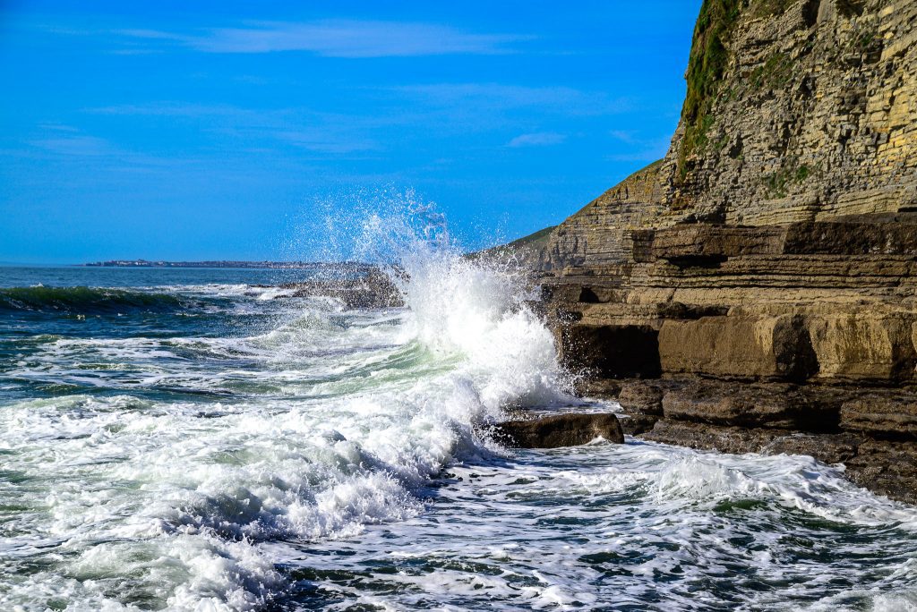 Waves break over the rocks