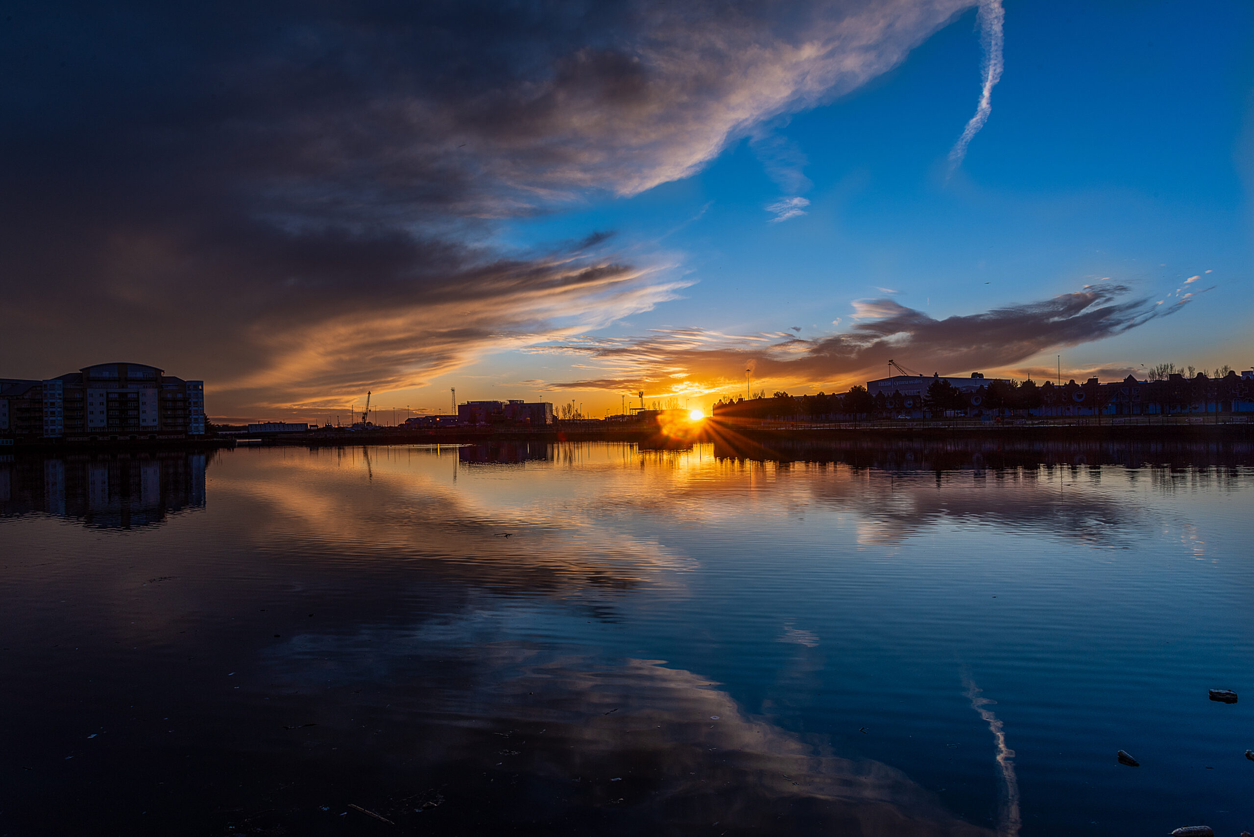 Dramatic golden hour sunset over Roath Basin in Cardiff Bay, captured by South Wales photographer Charlie Hannah.