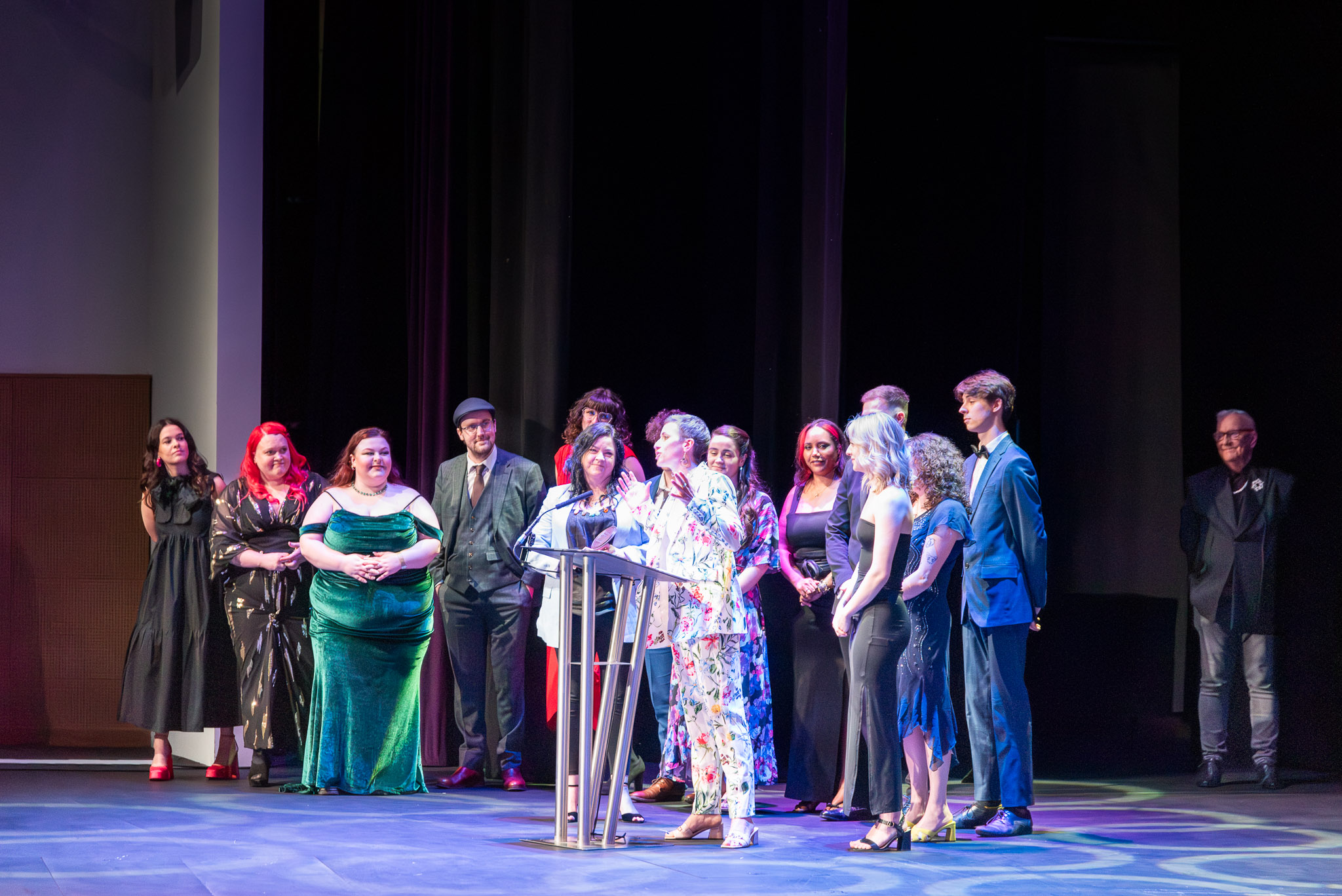 The cast and crew of New Beginnings stand on stage as an acceptance speech is delivered at the It's My Shout Awards at ICC Newport.