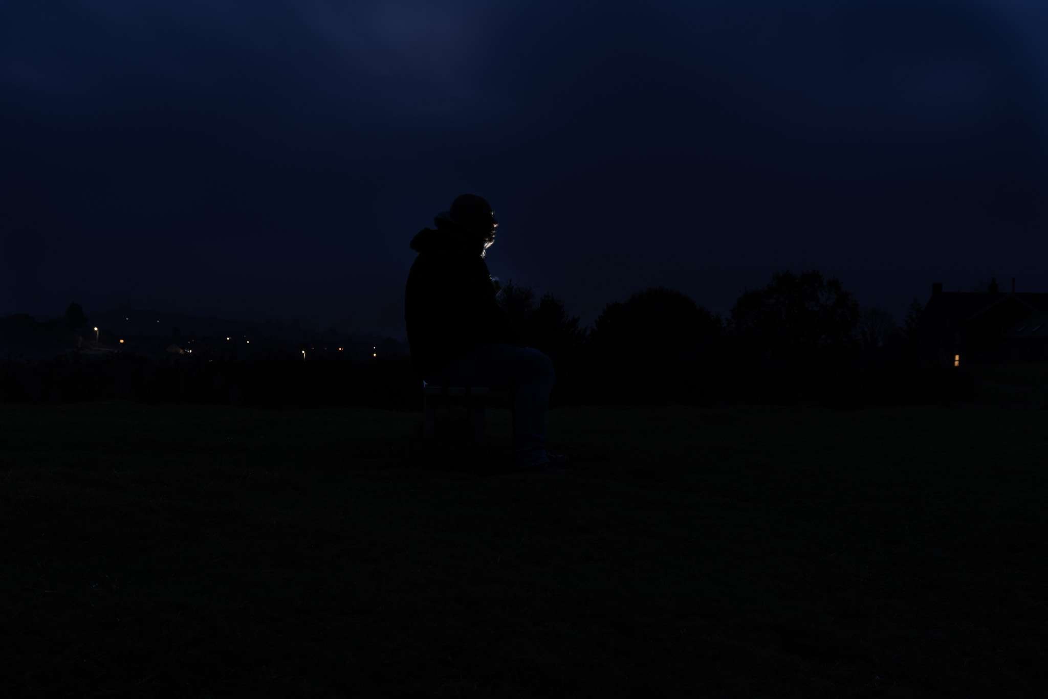 a man sits alone in the dead of night part of a project by charlie hannah documenting mental health struggles