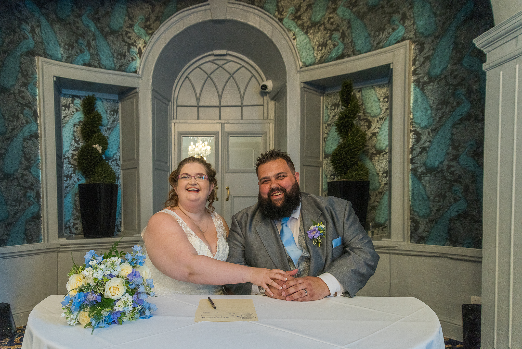 bride and groom beaming to the congregation after signing the register