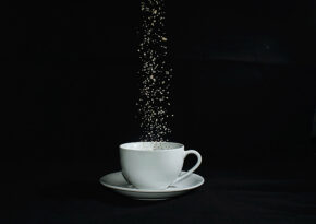 A still life study of sugar falling into a teacup photographed by South Wales photographer Charlie Hannah