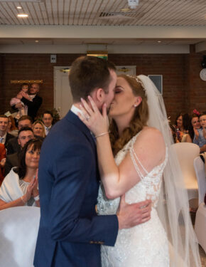 the-bride-and-groom-share-a-first-kiss-in-this-candid-portrait-by-charlie-hannah