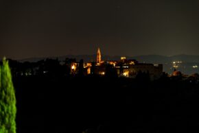 Collepepe, The historic Umbrian village glowing under the evening sky The illuminated hillside village of Collepepe in Umbria glowing against the dark night sky