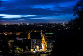 Paris Skyline - February 2020 High-angle night view overlooking the illuminated Paris skyline and strelit streets from Montmartre under a deep blue cloudy sky, February 2020.
