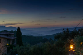 Relais Il Cannalichio, Umbria, September 2018 The coming dawn over the rolling hills and misty valleys of Umbria viewed from Relais Il Cannalichio with a warm garden lantern in the foreground