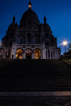 Sacré-Cœur Basilica, Paris - February 2020 Sacré-Cœur Basilica illuminated under a deep blue twilight sky with figures on the steps in Paris, captured in February 2020.