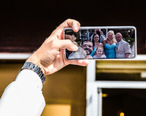 Candid wedding photo reflection of photographer Charlie Hannah capturing guests taking a selfie at a Welwyn Garden City wedding