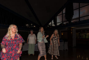 Wedding guests dancing and enjoying the evening reception under the high wooden beams and windows of the Stourbridge Registry Office venue.