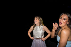 wo wedding guests laughing and having fun on the dancefloor during evening celebrations in South Wales.