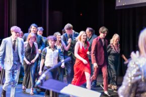 Group of award winners and participants walking across a stage during an event, photographed by South Wales event photographer Charlie Hannah