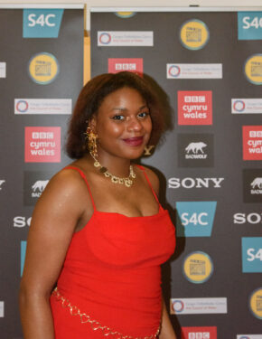 A guest associated with Bad Wolf posing on a red carpet media wall in Cardiff, photographed by South Wales event photographer Charlie Hannah