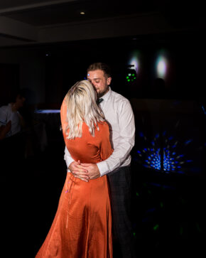 A candid, unposed photograph of a couple sharing an intimate moment on the dance floor during evening wedding shenanigans, captured by Charlie Hannah.