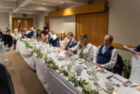 Candid wedding reception photography capturing speeches at the top table at Lea Marston Hotel, Sutton Coldfield by Charlie Hannah.